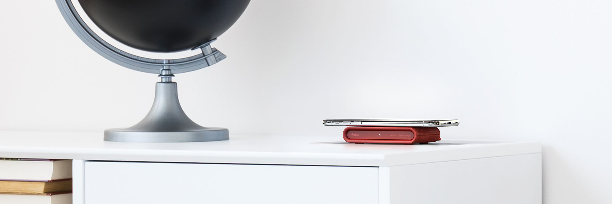 iottie.comionw-mini_ruby_lifestyle iON Wireless Mini Charging Pad in Ruby on an Office Desk