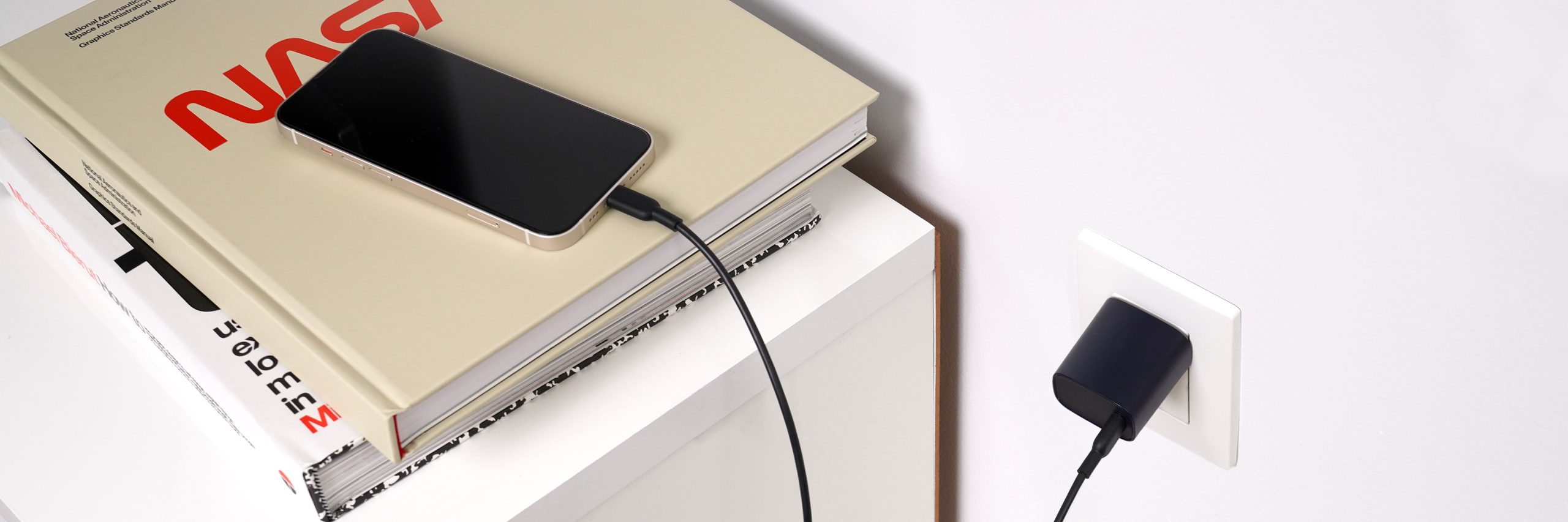 rapidvolt_wall-charger_lifestyle_02 RapidVolt 20W Wall Charger Power Adapter Plugged into Wall Outlet & Charing Phone on Table
