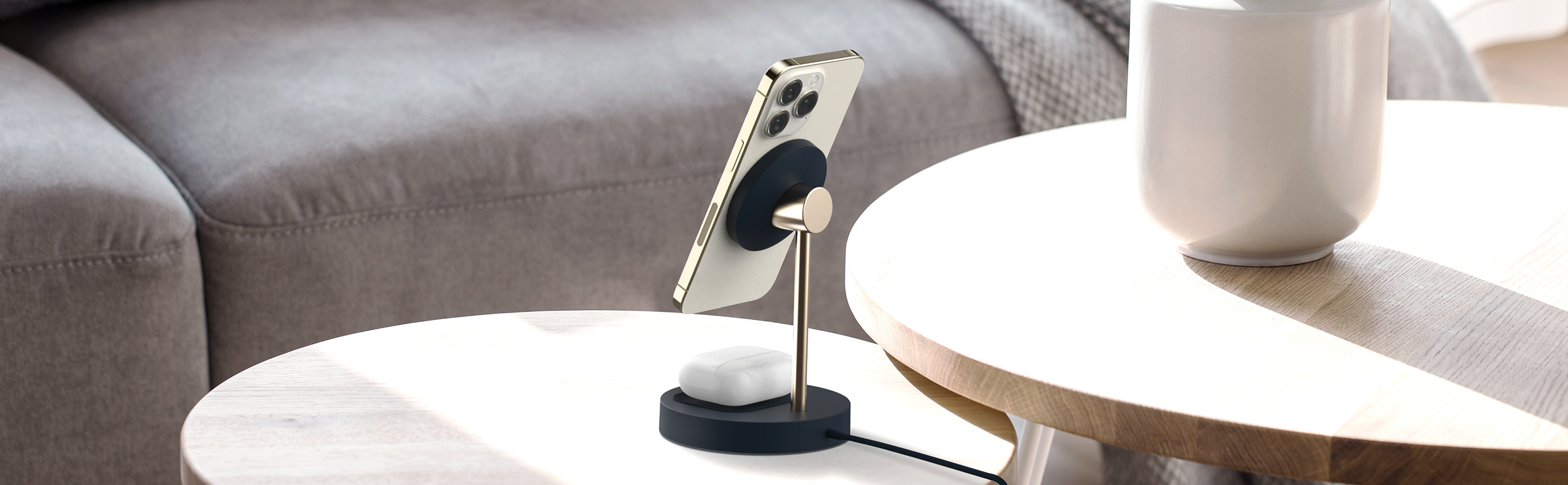iottie.comvelox-magnetic-wireless-charging-duo-stand_lifestyle Velox Magnetic Wireless Duo Stand Dual Charger for MagSafe iPhones & Qi Accessories Displayed on Living Room Table