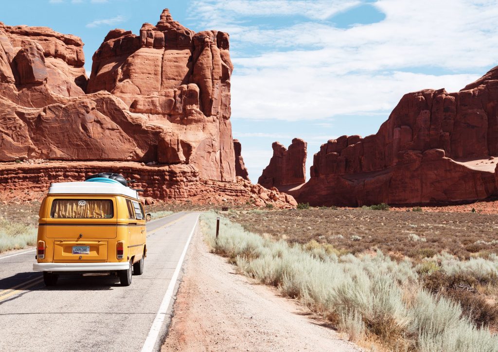 Yellow VW van driving through Arches National Park