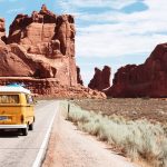 Yellow VW van driving through Arches National Park